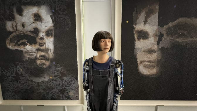 AI artist Ai-Da and "AI God", a portrait of Alan Turning.