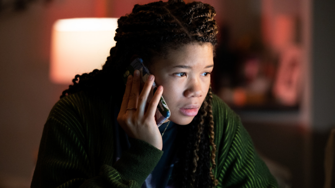 A teenage girl speaks on the phone. 